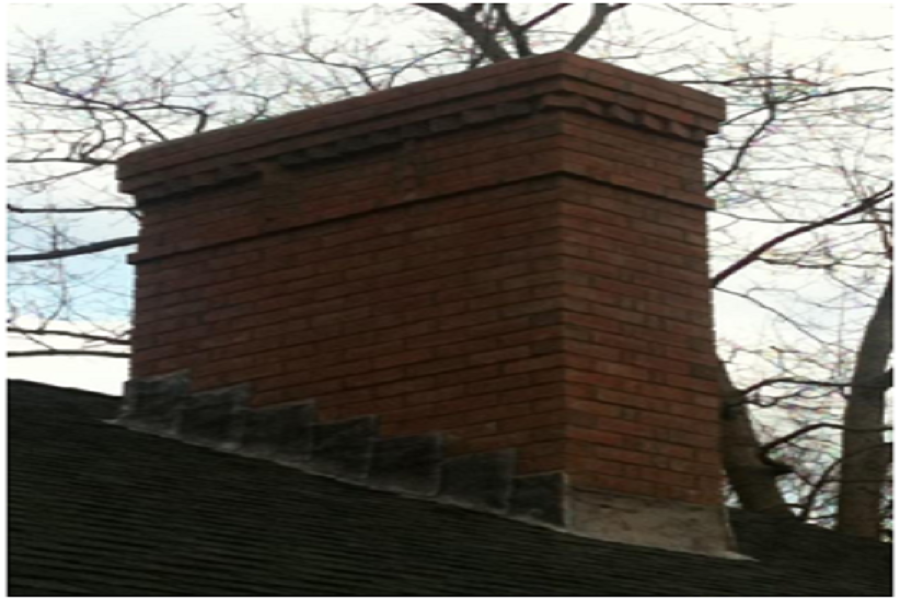 Large brick chimney in a house. 