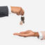 Real estate agent giving house keys to a client