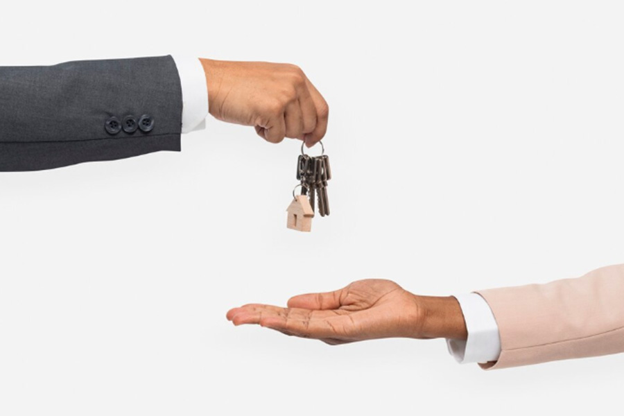 Real estate agent giving house keys to a client